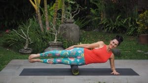 Side plank exercise using a roller under your leg