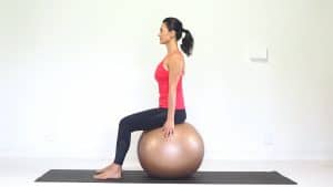 sitting on a fitball. Learn how to stop slouching